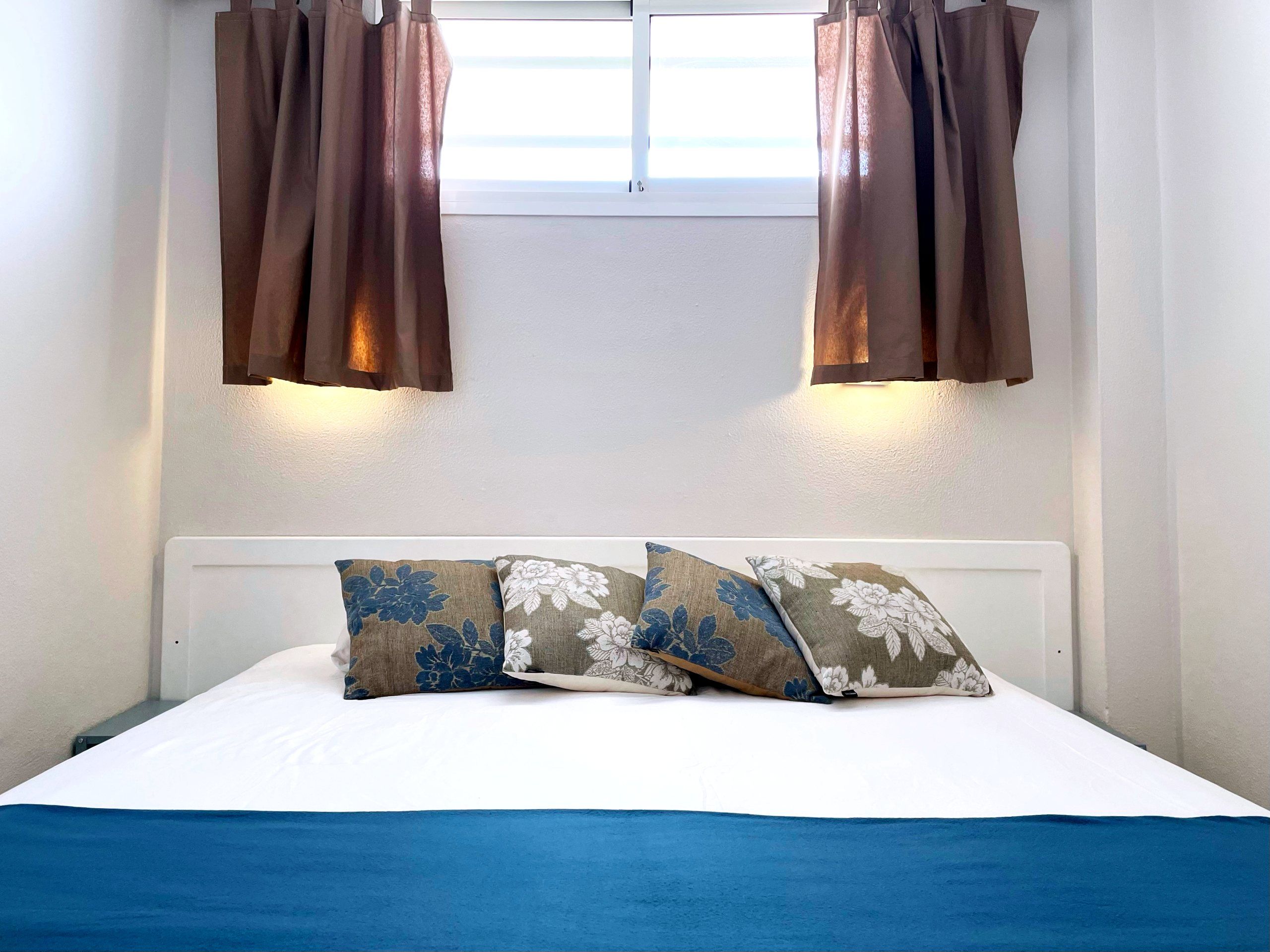 Bedroom with double bed and blue bed runner