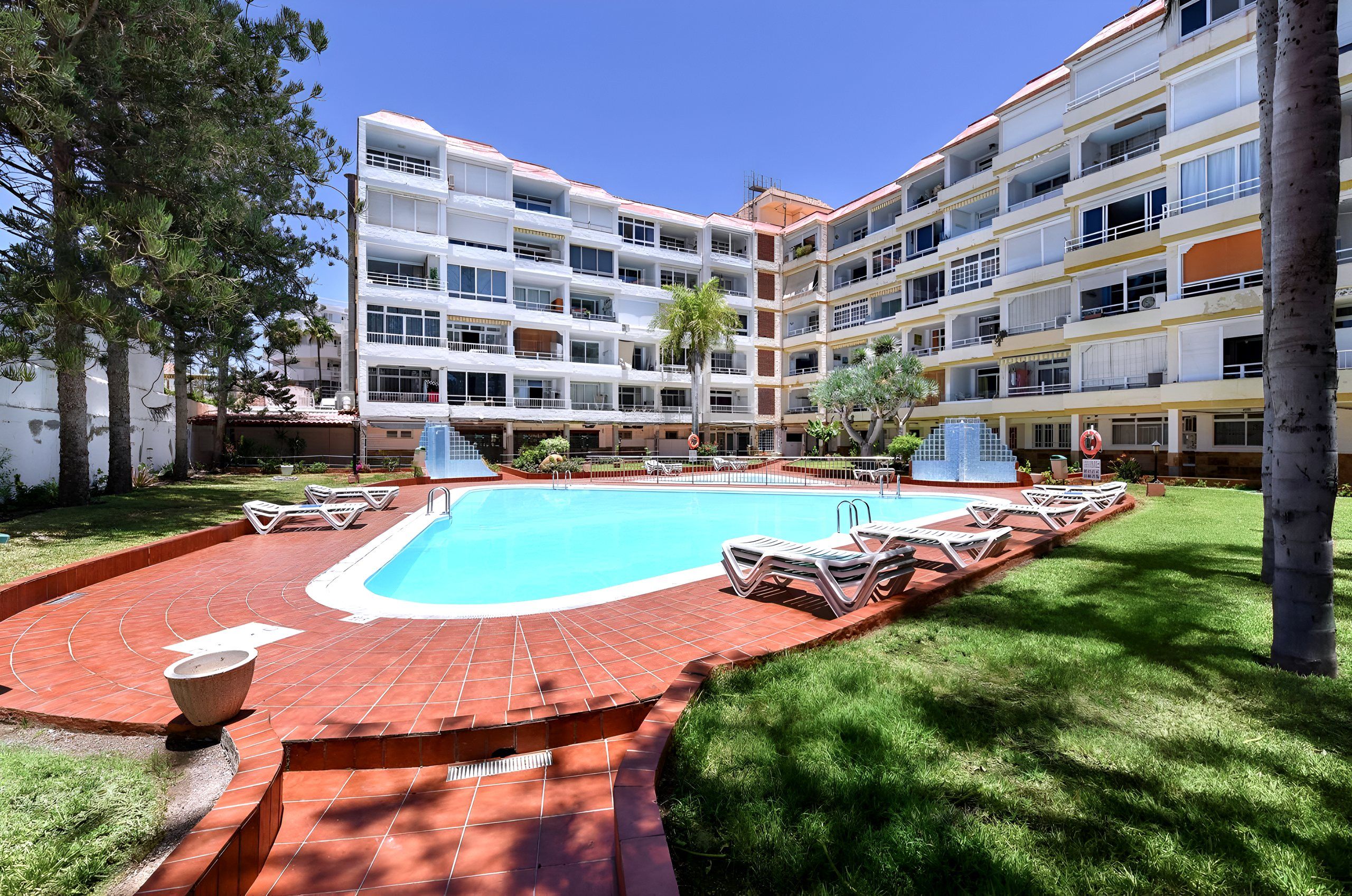 Swimming pool and garden in front of the apartment block